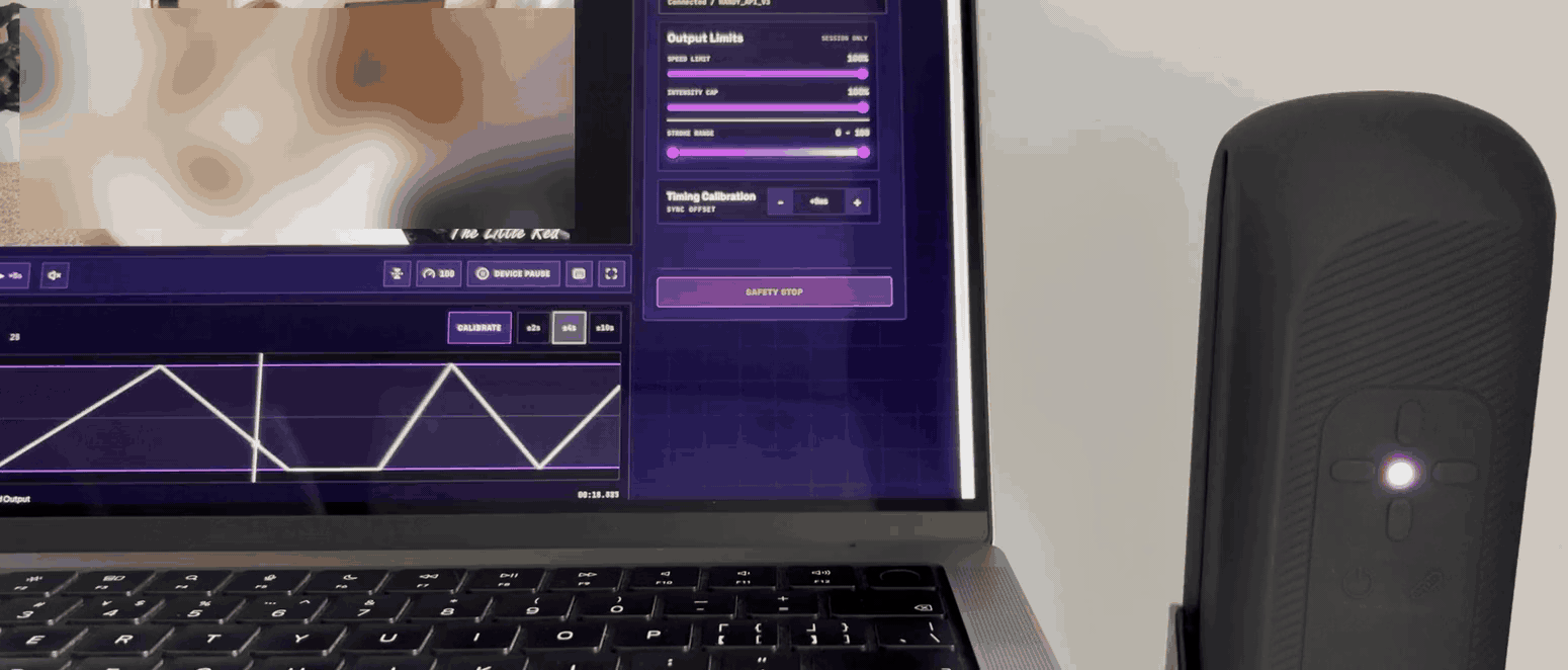 A Handy stroking beside the laptop, driven by the funscript on screen